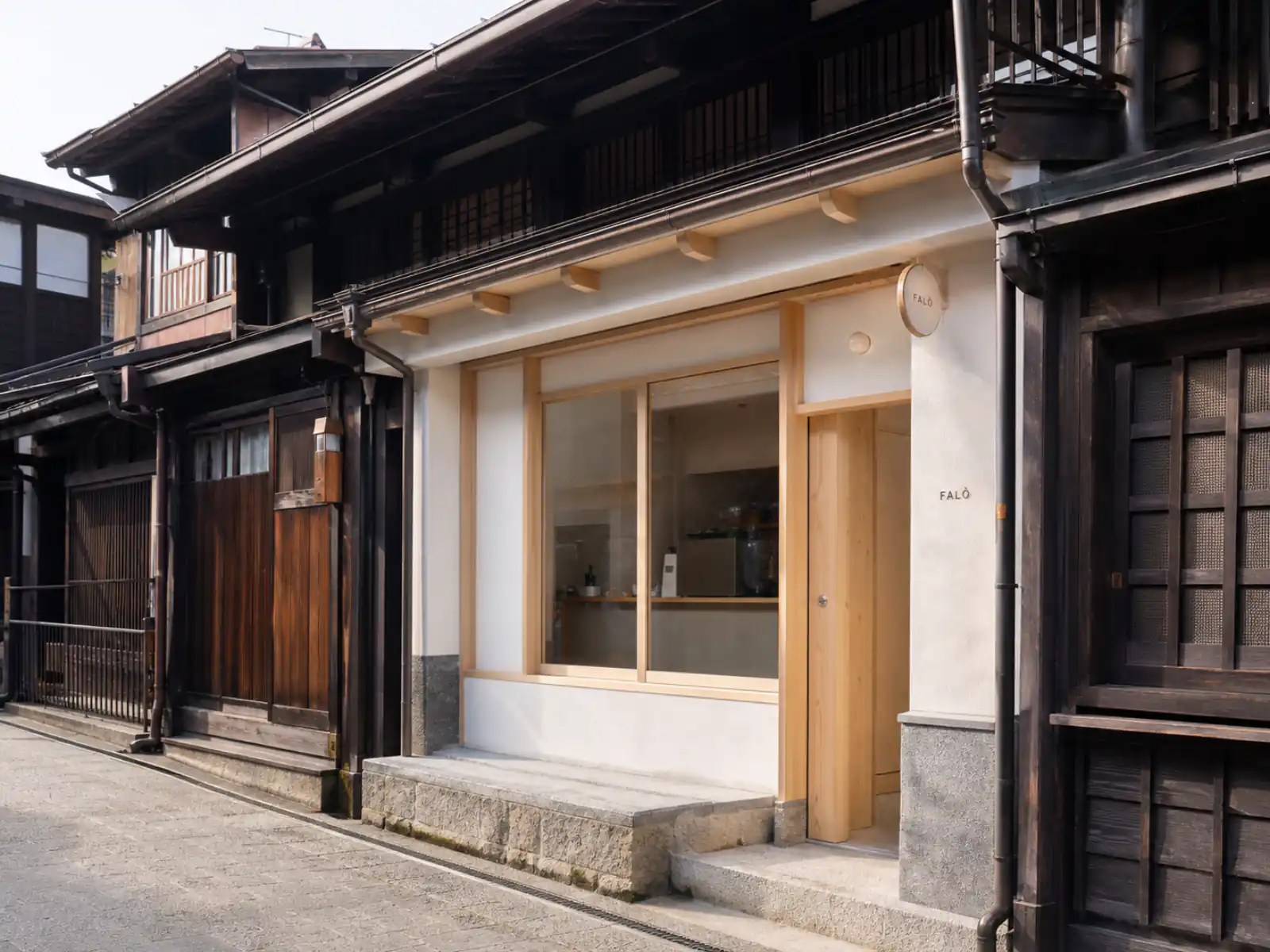 Falò Coffee Brewers storefront in Takayama's old town — light wood and white walls on a historic street