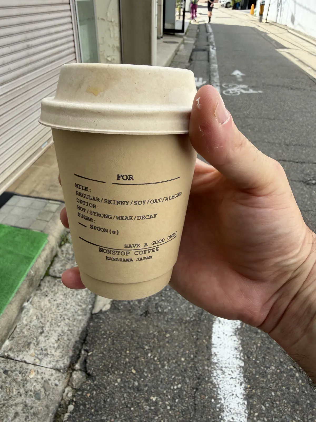 Nonstop Coffee cold brew served in the shop's branded paper cup and lid
