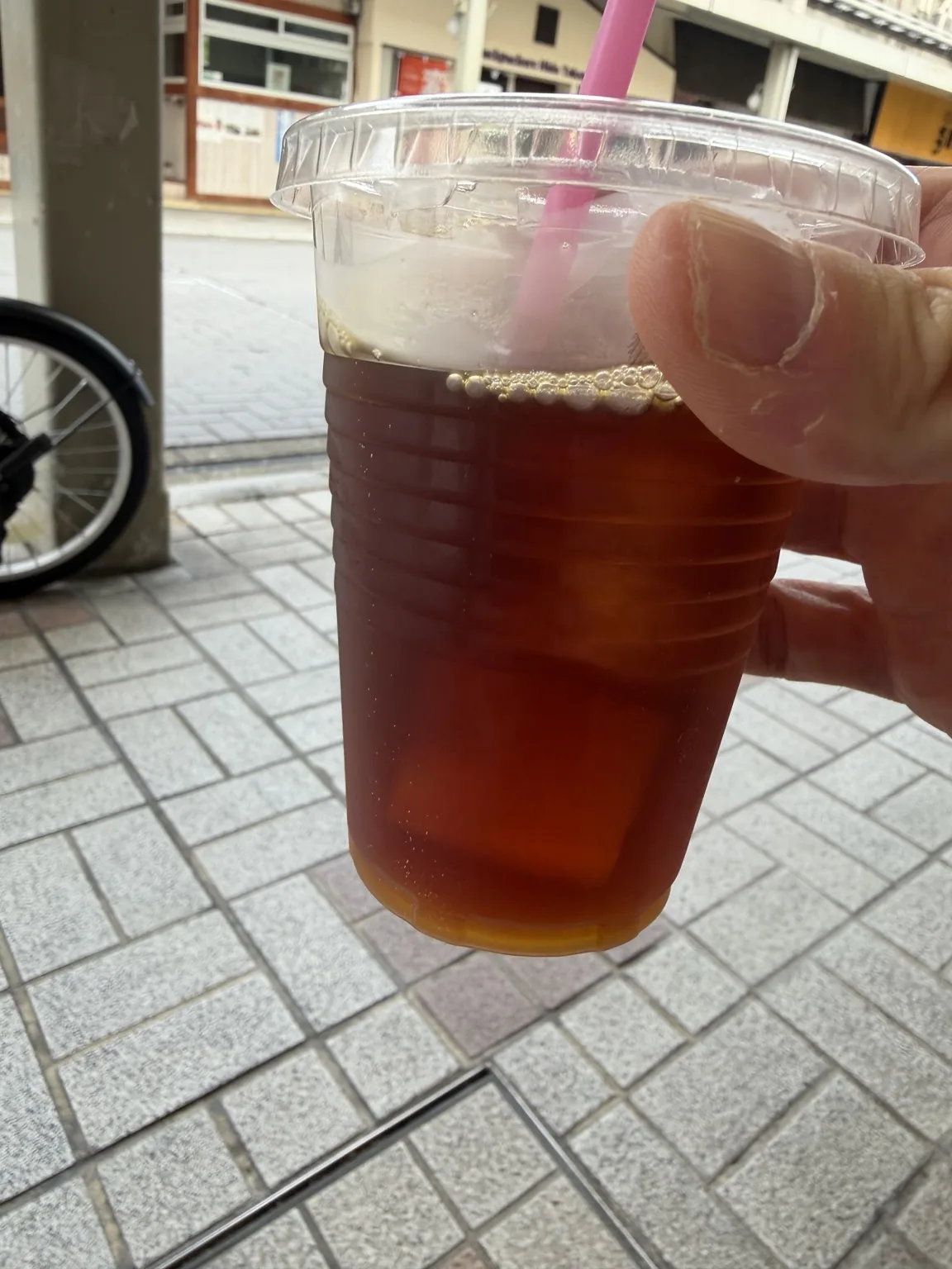 Iced pour over from SANU Coffee Stand, a clear reddish-brown cup over ice