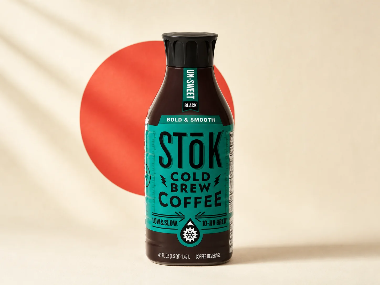 STōK Un-Sweet Black cold brew bottle on a warm cream background